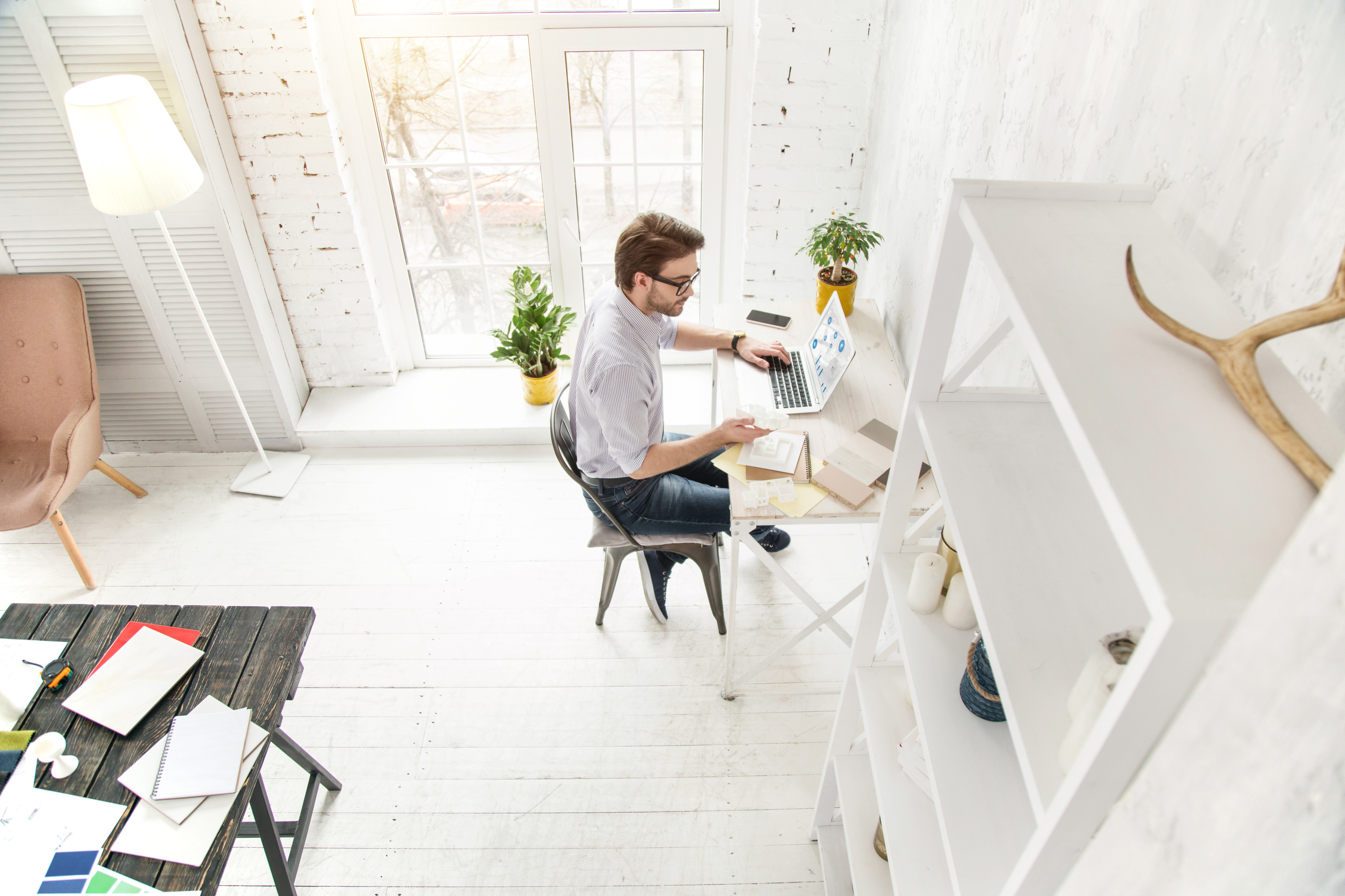 Ashton Newland, founder of SteadyBooks, working with financial reports in a clean professional workspace